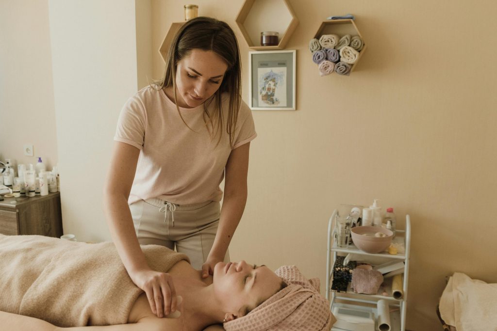 A serene spa treatment featuring a skilled masseuse offering a soothing massage in a calming indoor environment.