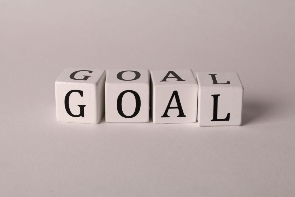 White letter blocks spelling 'Goal' on a neutral backdrop, ideal for business themes.