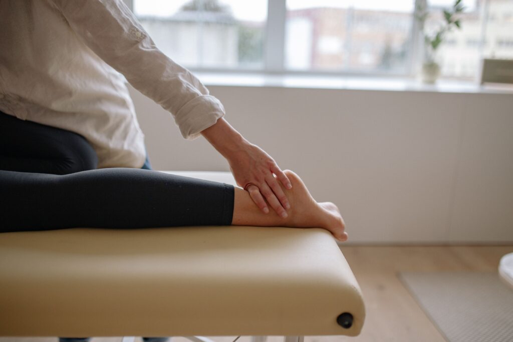 Close-up of a woman's foot receiving a relaxing massage in a wellness setting.